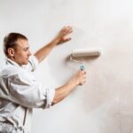 worker-painting-wall-with-roller-white-color (1)